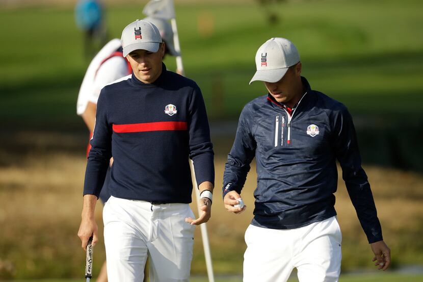 Jordan Spieth of the US, left, and Justin Thomas of the US walk together during a foursome...