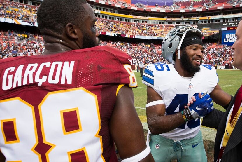Dallas Cowboys running back Alfred Morris shakes hands with former teammates, including...