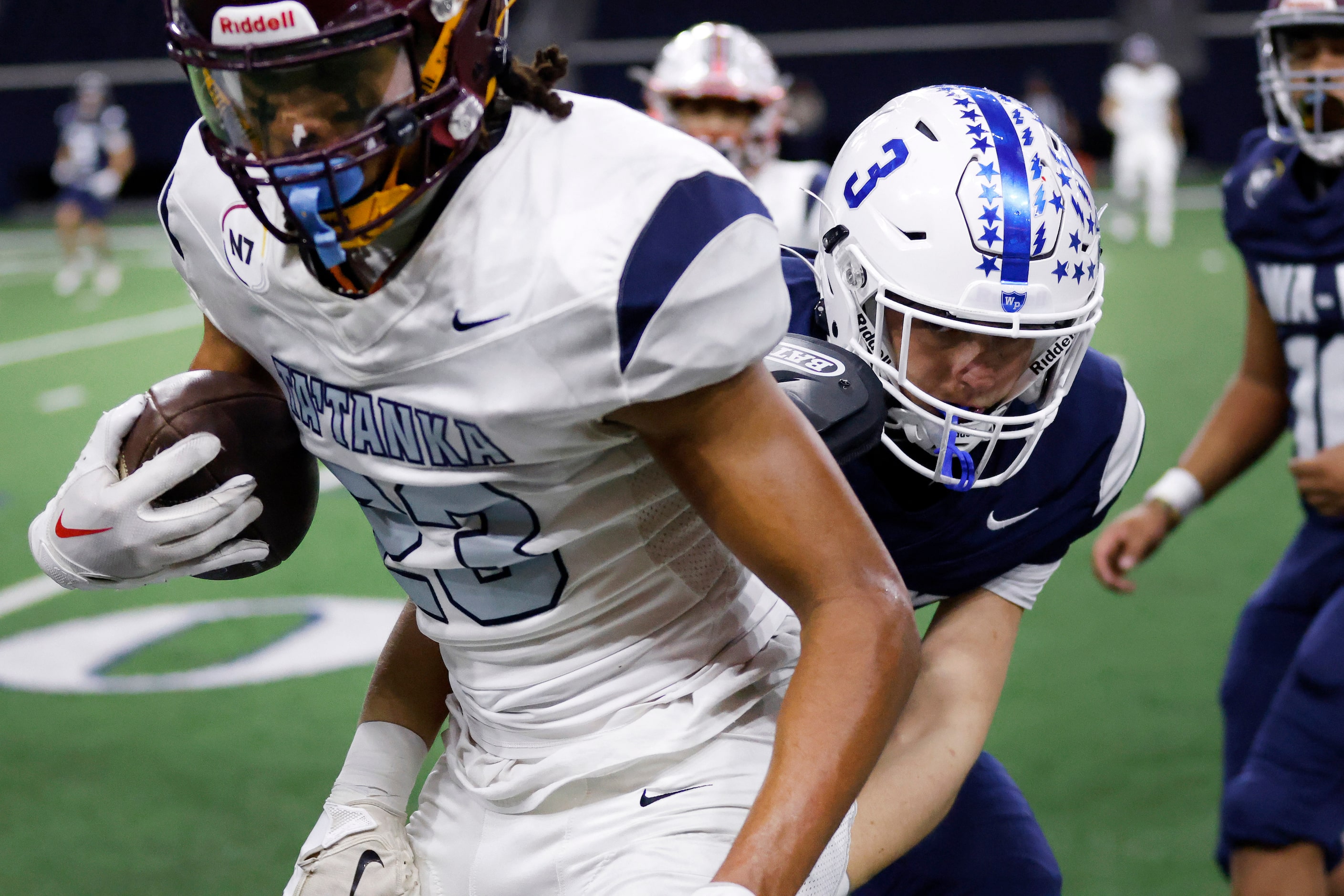 Wa-Ya defensive back Cooper O’Neal (right) of Wills Point High (TX) tackles Ta’ Tanka El...