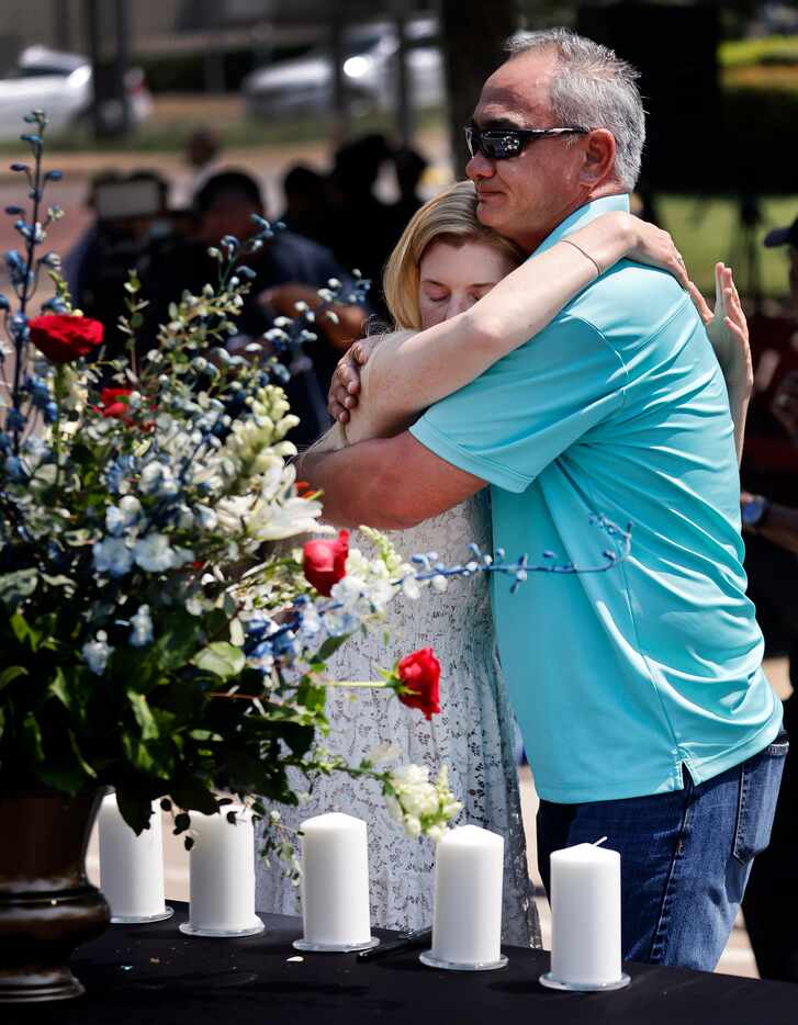Heidi Smith, widow of fallen Dallas police Sgt. Michael Smith, hugs Michael's brother, Billy...