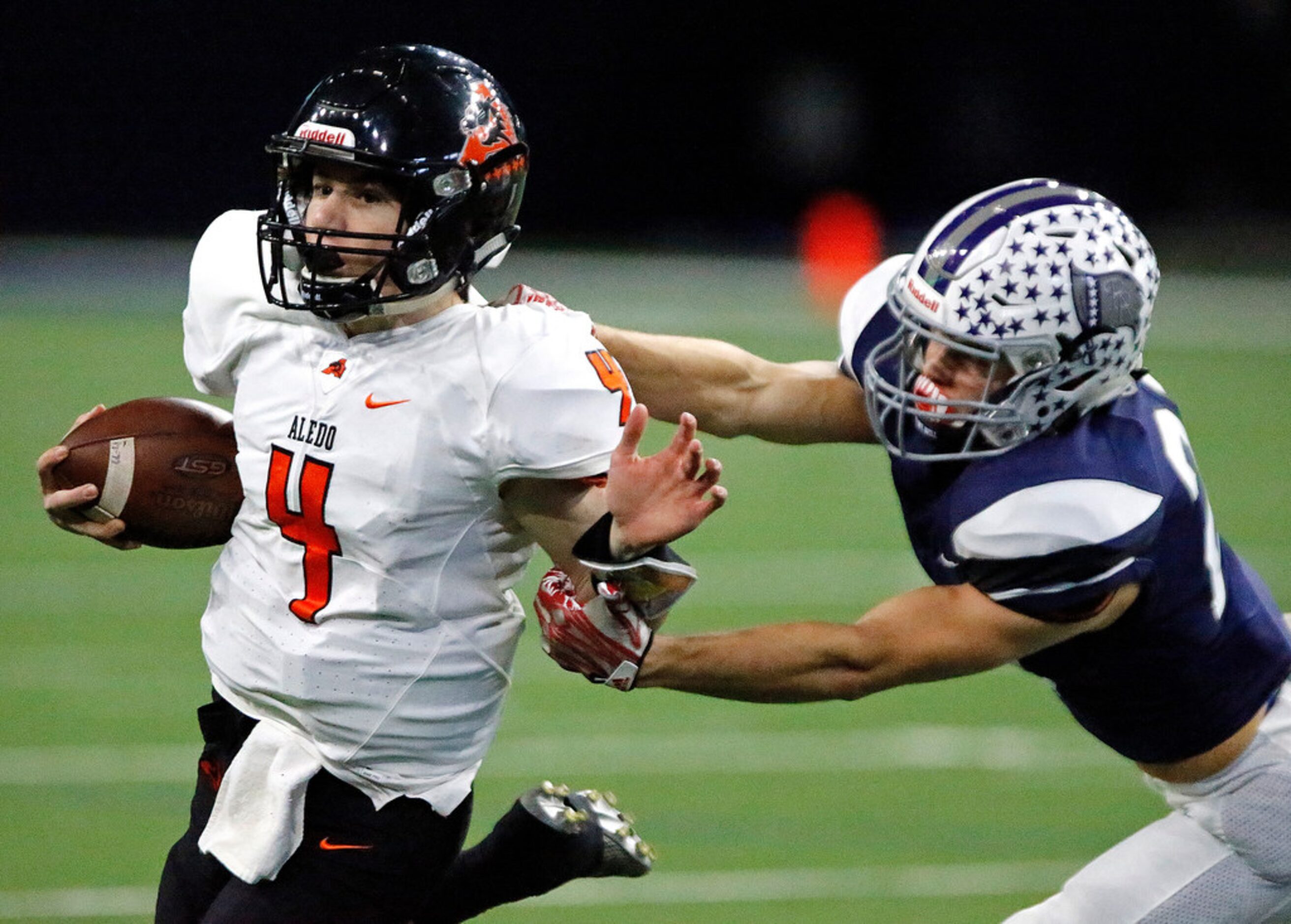 Aledo High School quarterback Jake Bishop (4) is horse collared by Richland High School...