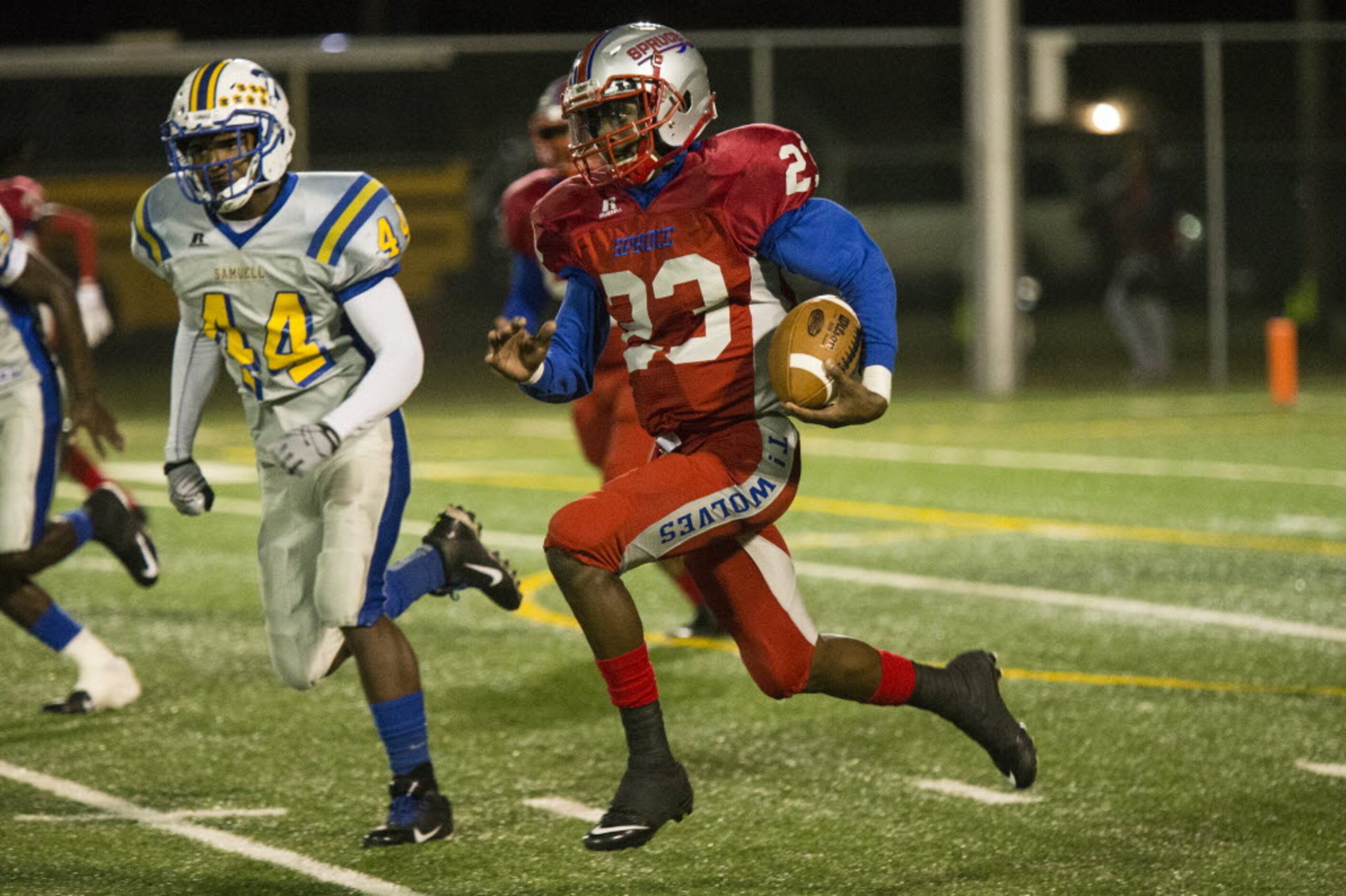 Spruce's Travion Hardman (23) breaks for a long rush during W. W. Samuell's matchup against...