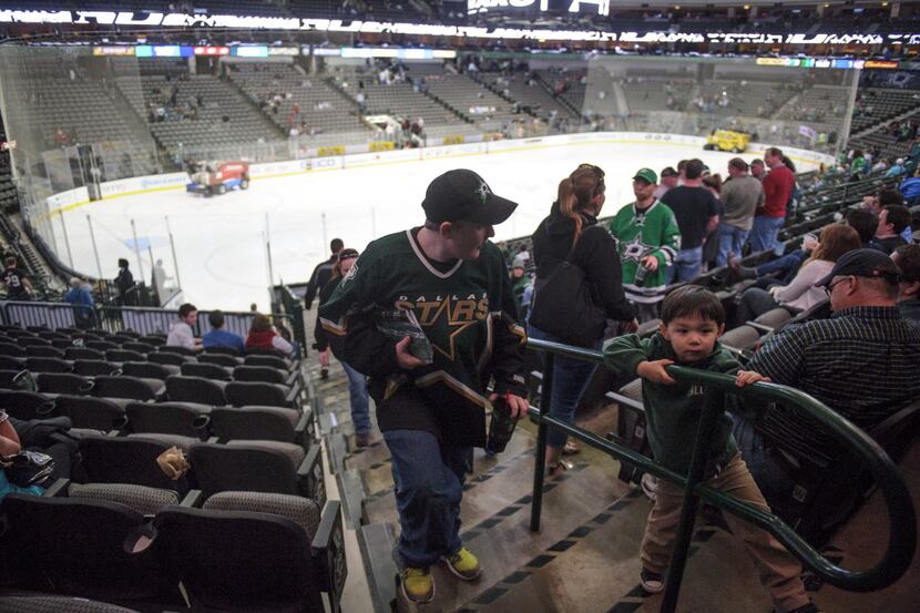 Stars fans exit the rink after the postponement of the Dallas Stars game against the...