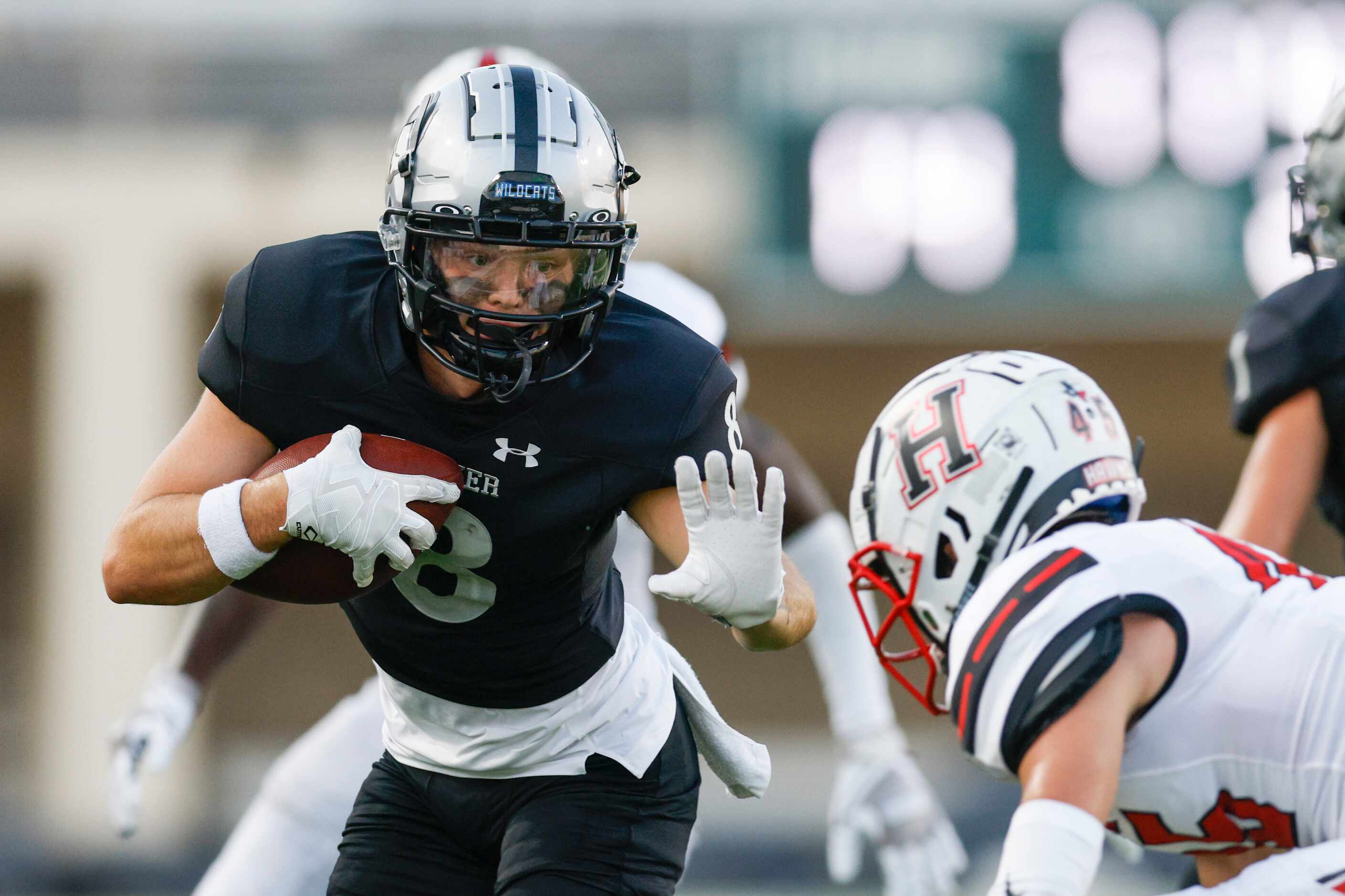 Denton Guyer wide receiver Blade Carver (8) prepares to stiff-arm Rockwall-Heath Chase...