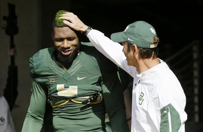 Baylor defensive end Shawn Oakman (2) gets a pat from head coach Art Briles before an NCAA...