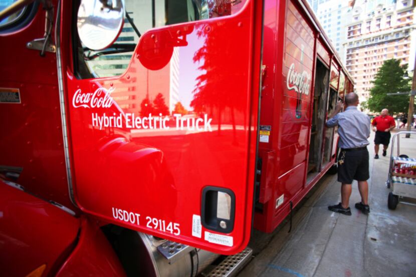 Cody Felts, 32, unloads Coca-Cola products from his hybrid delivery truck. The hybrid truck...