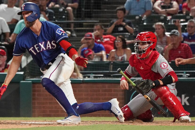 Texas Rangers' Hunter Pence drops his bat after hitting a single to drive in the winning run...