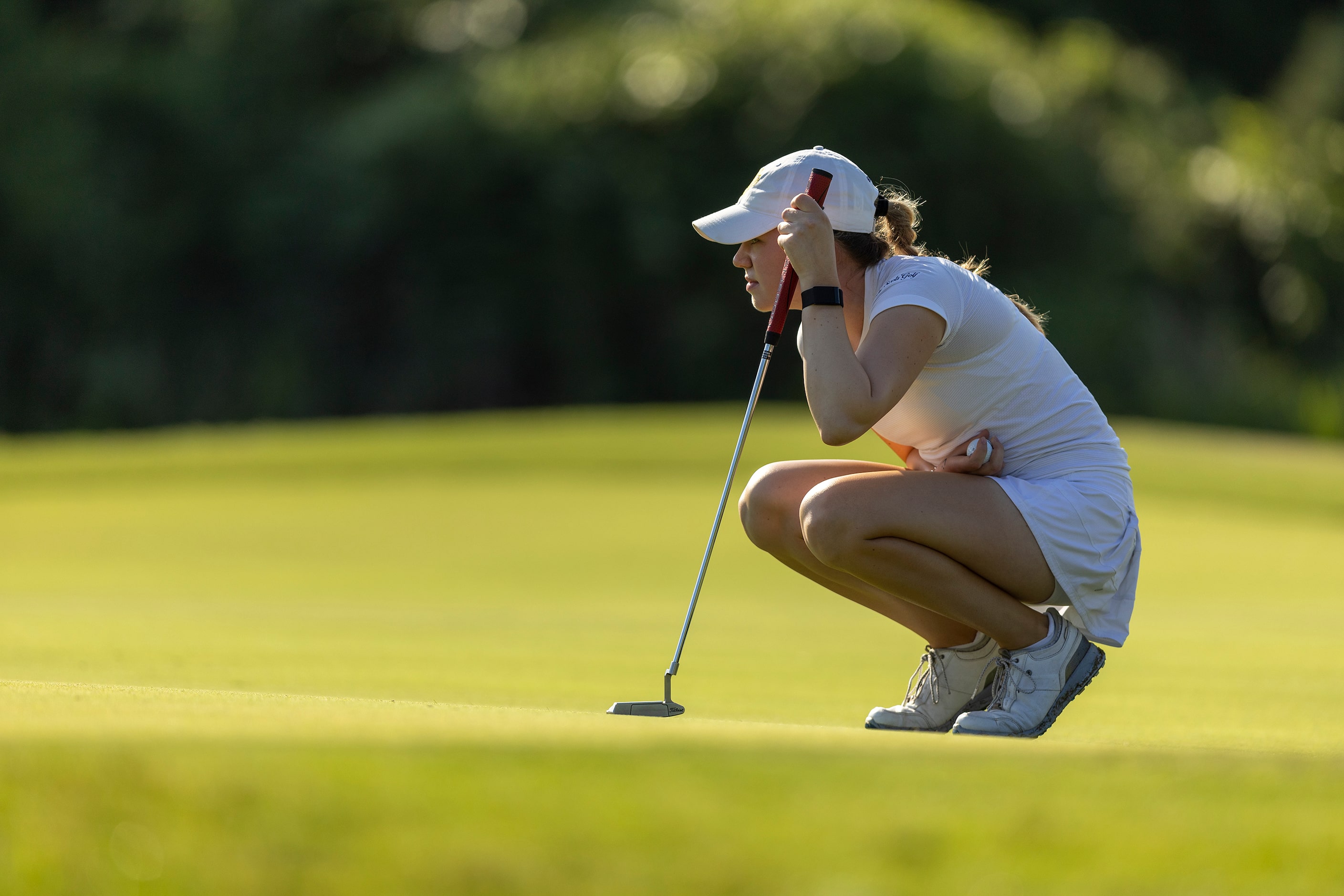 Highland Park’s Sophie Biediger studies her shot on the 1st green during the 5A girls state...