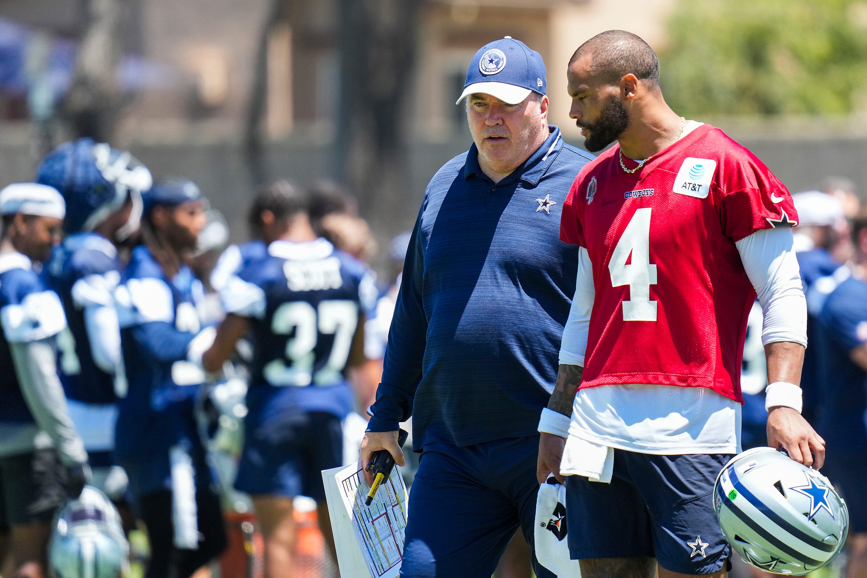 Dallas Cowboys quarterback Dak Prescott (4) talks with head coach Mike McCarthy during a...