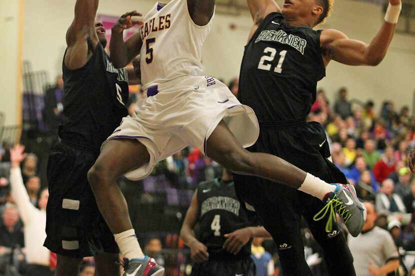 Richardson High School's Brandon Arevette (5) shoots the basketball between Berkner...