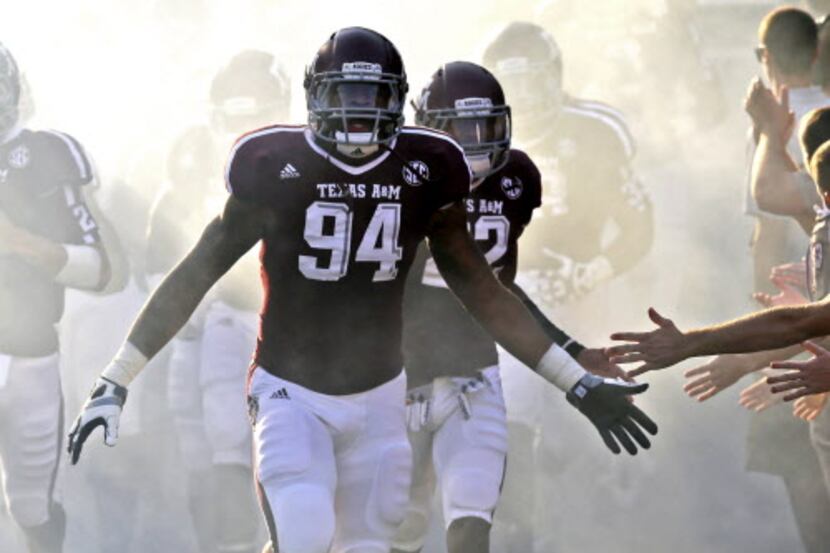 In this photo taken Sept. 22, 2012, Texas A&M's Damontre Moore (94) leads the team out to...