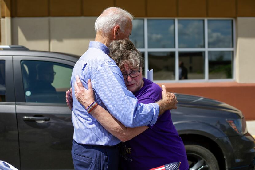 Former vice president and 2020 presidential candidate Joe Biden consoles Belinda Scavone as...