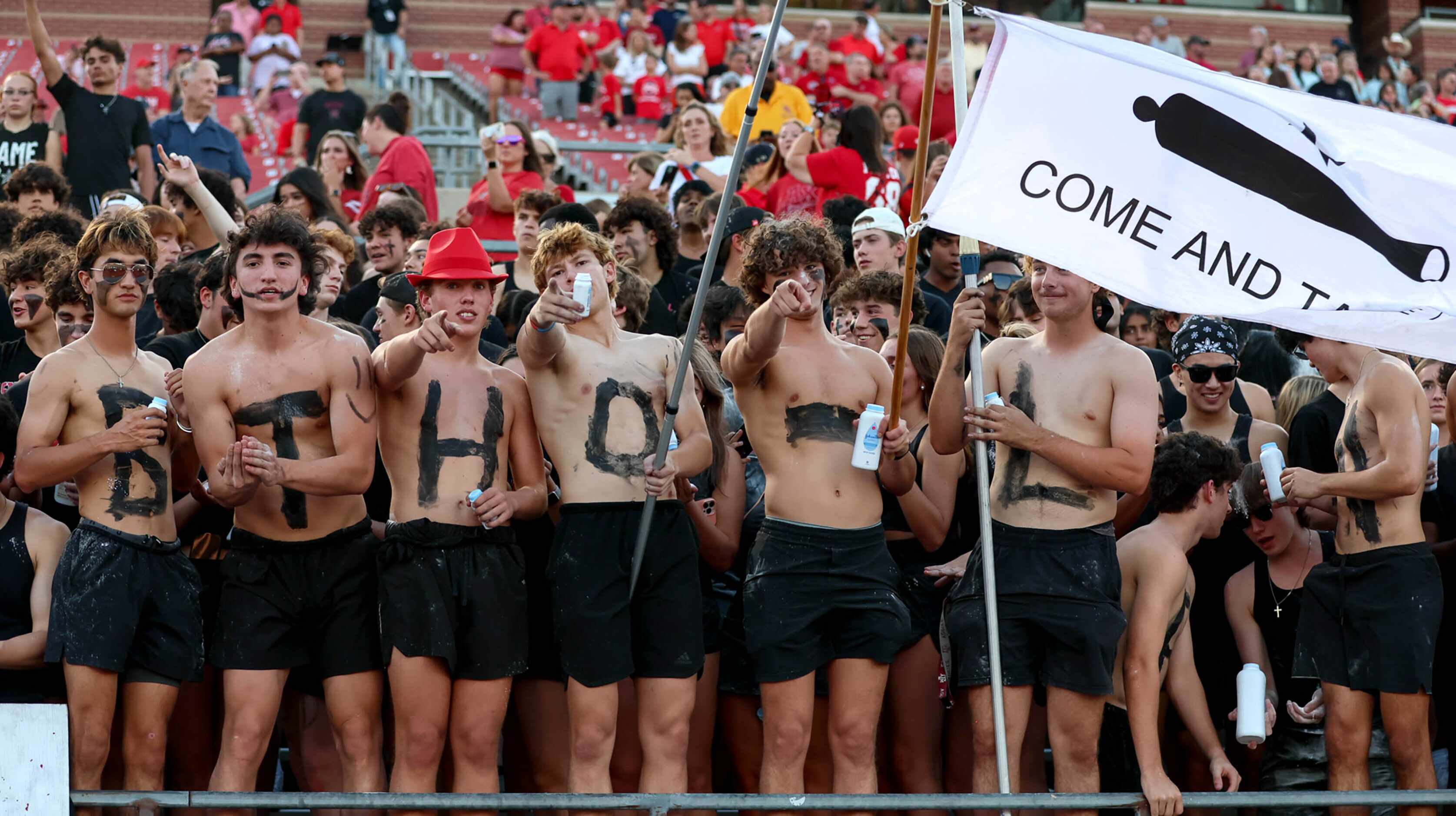 The Coppell students get ready to cheer on their Cowboys against Lewisville in a high school...