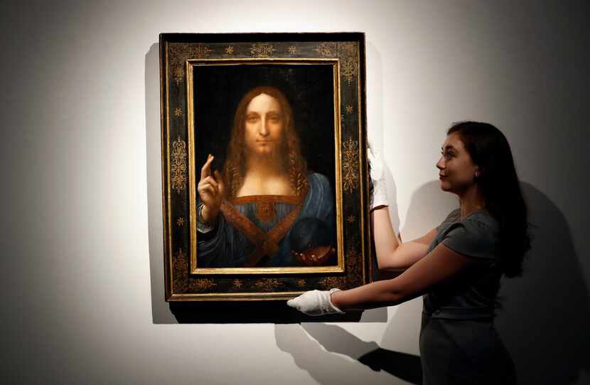 An employee poses Oct. 24 with Leonardo da Vinci's Salvator Mundi on display at Christie's...