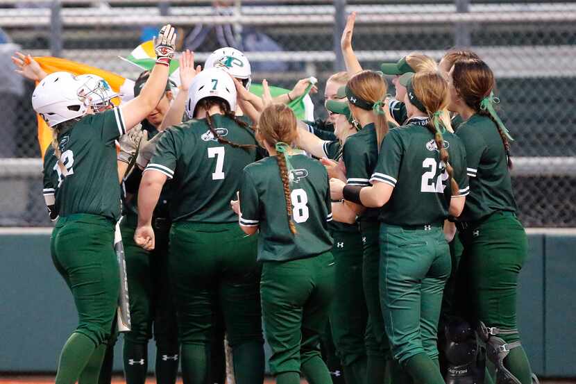 Prosper High School first baseman Sydney Lewis (7) is mobbed by team mates after hitting a...