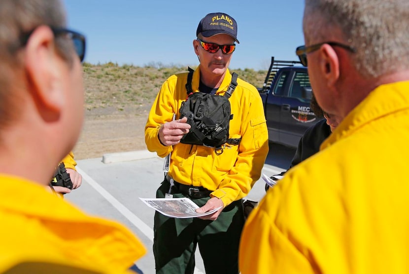 
Plano Fire-Rescue's Michael Covey goes over the plan with the team before starting a...