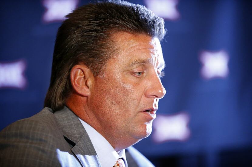 Oklahoma State head football coach Mike Gundy answers questions at a breakout session during...