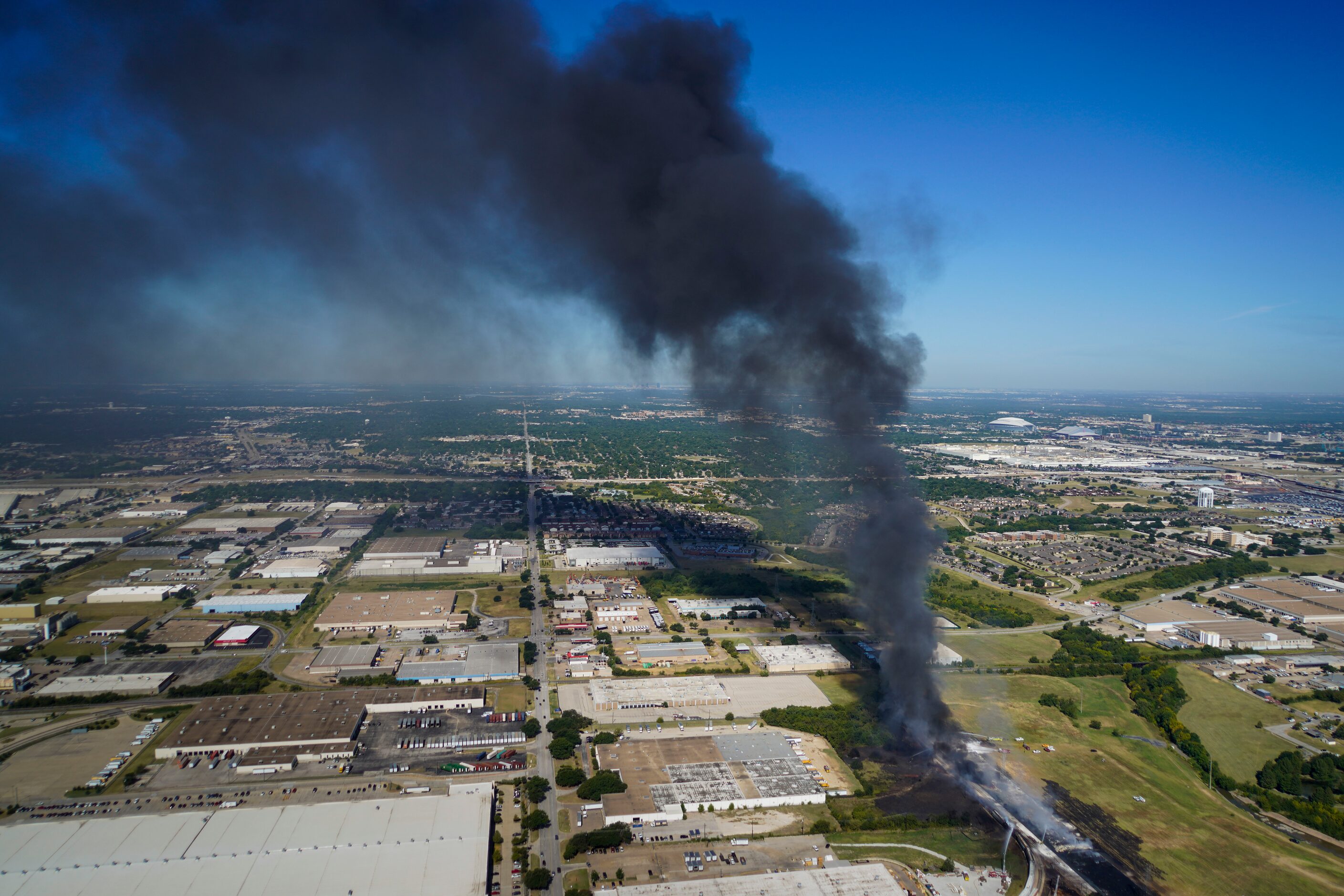 Aerial view of fire crews working at the site of a massive blaze in an industrial area on...