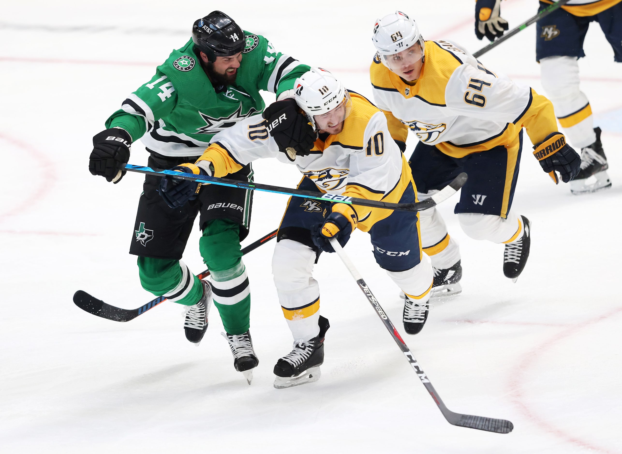 Dallas Stars left wing Jamie Benn (14) and Nashville Predators center Colton Sissons (10) go...