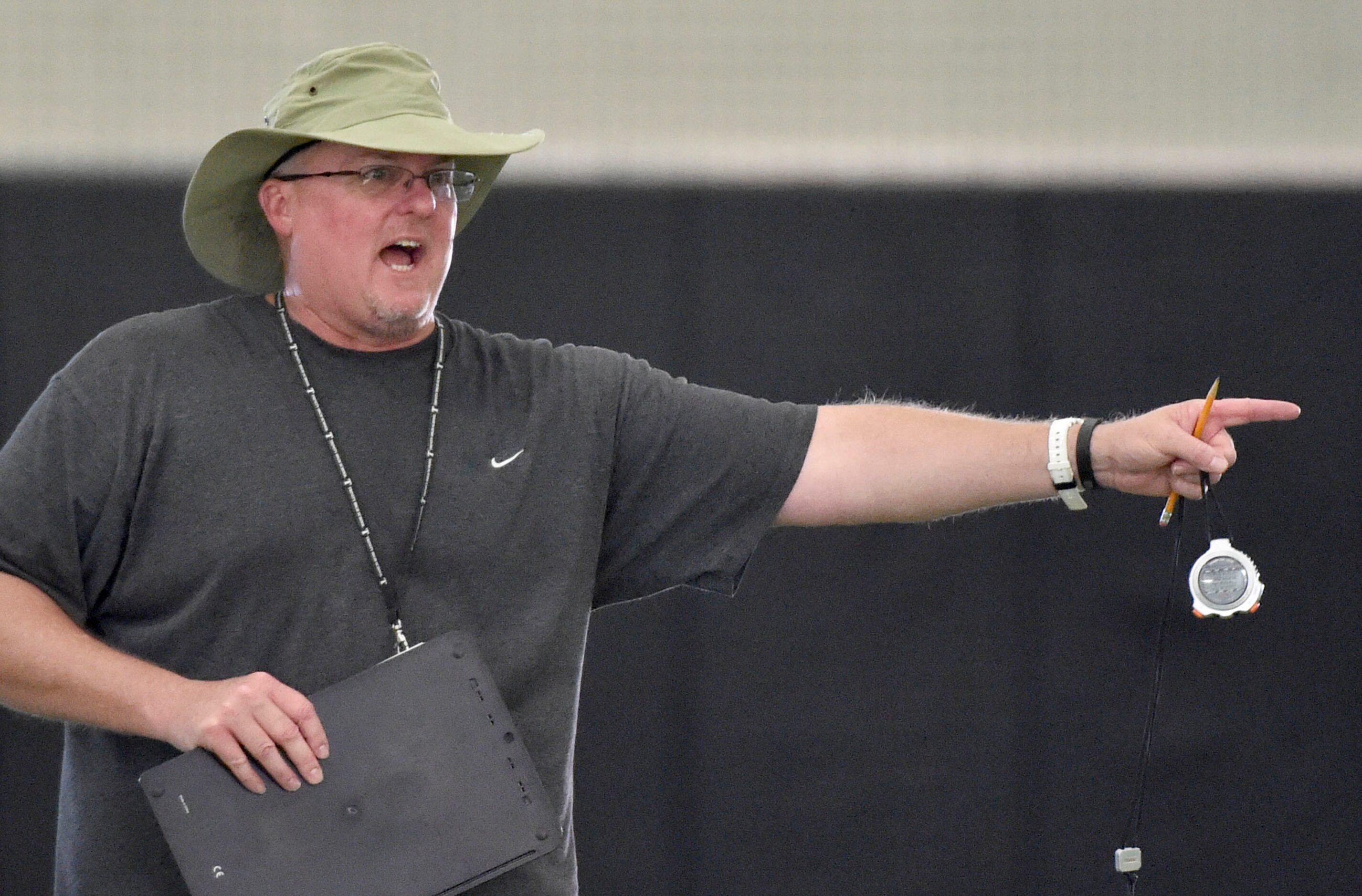 Coach Chris Jensen gives direction to his team during Euless Trinity's first day of football...