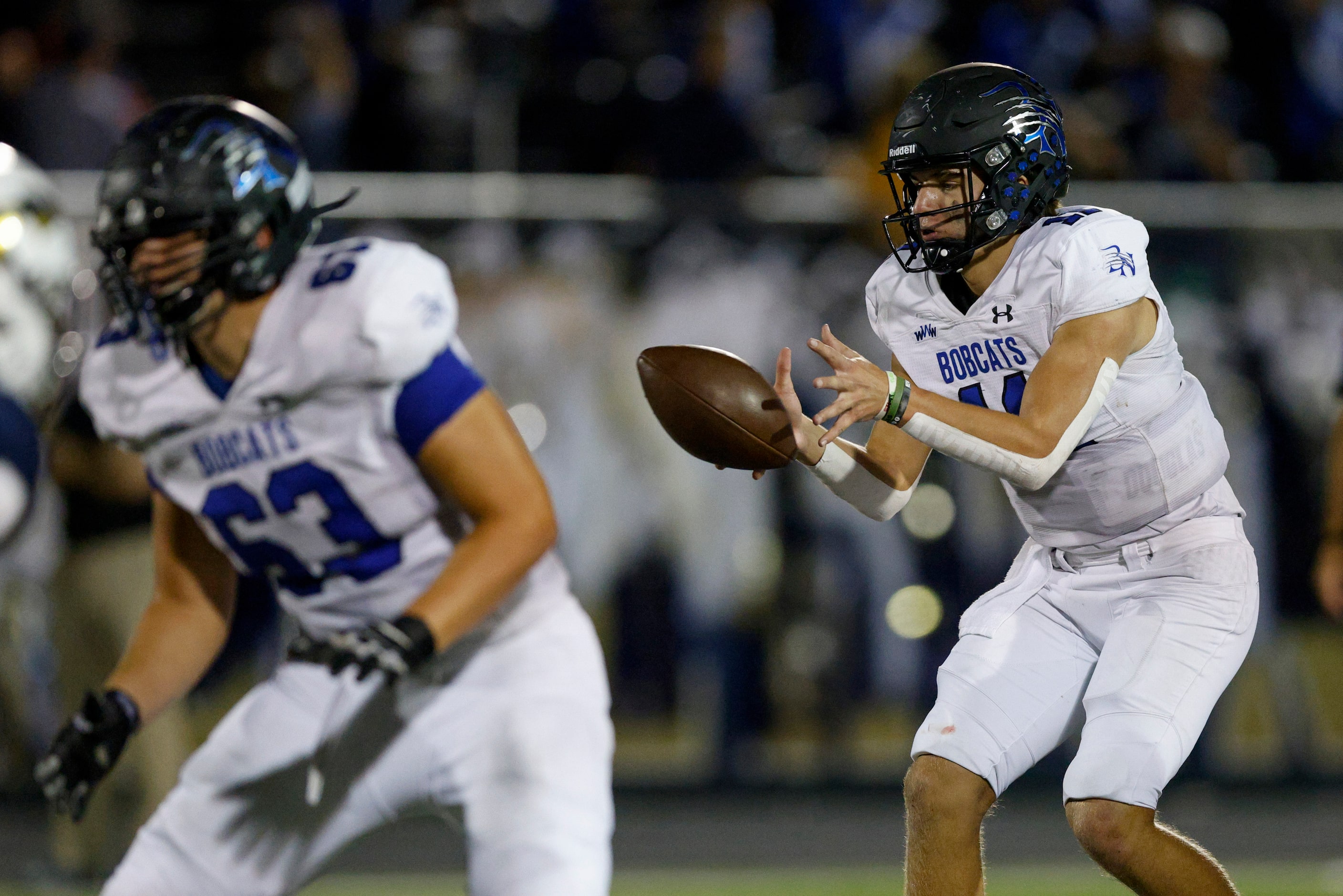 Trophy Club Byron Nelson quarterback Jake Wilson (11) takes the snap during the second half...