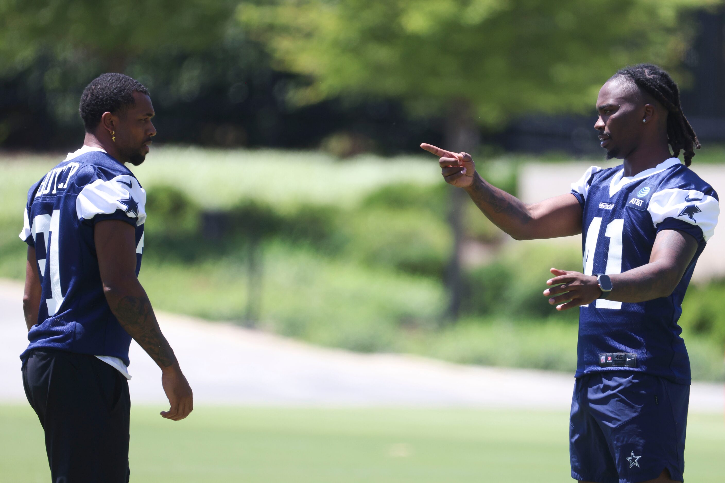 Dallas Cowboys defensive backs Josh Butler (left) interacts with Caelen Carson during a...