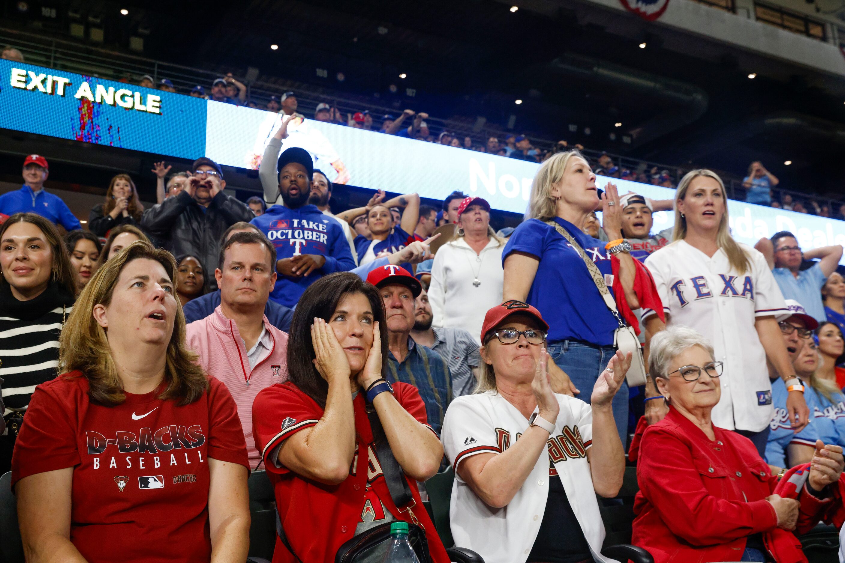 Arizona Diamondbacks fans react to Tommy Pham’s single against the Texas Rangers in the...