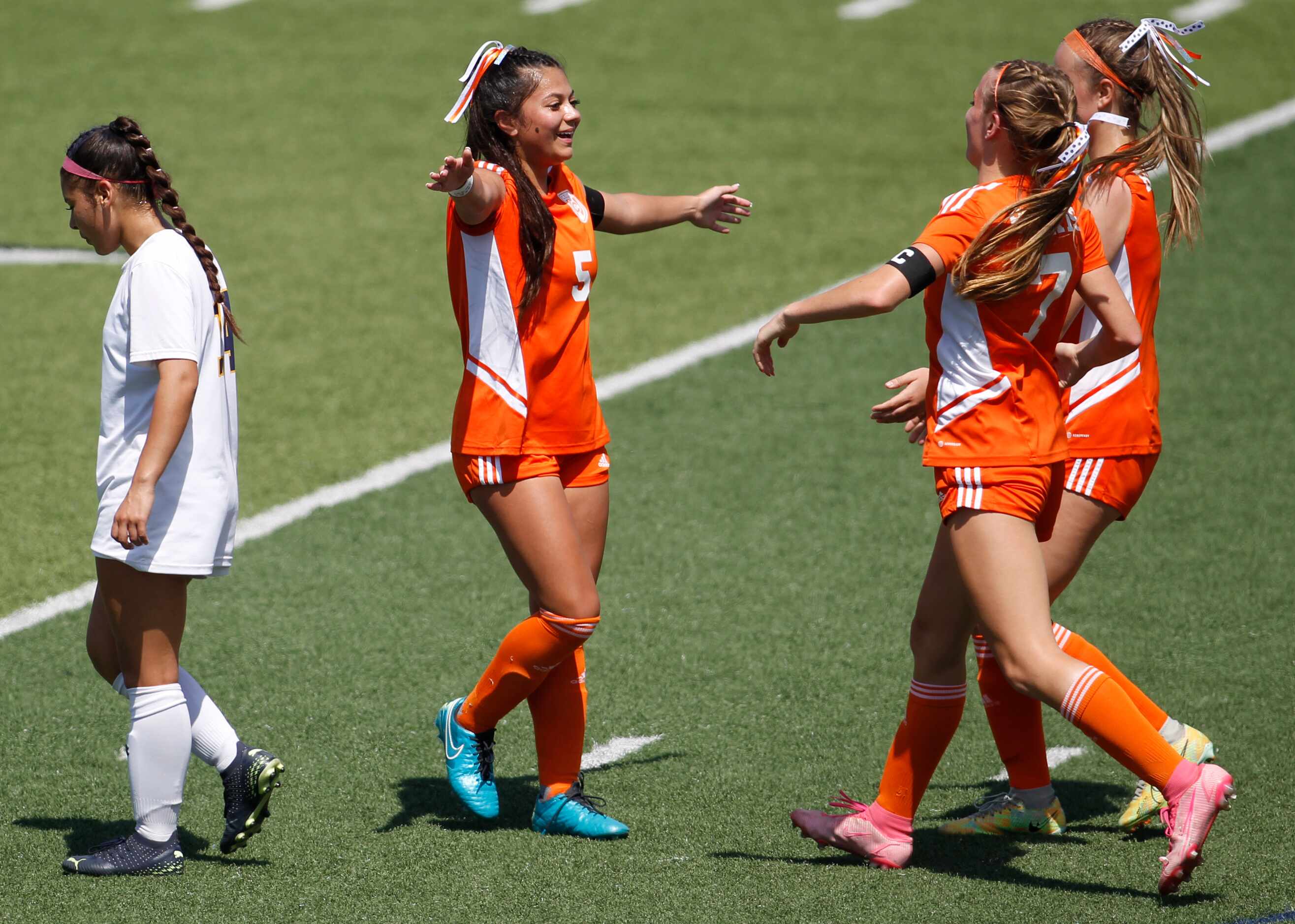 Celina midfielder Brielle Buchanan (5), center, welcomes teammates with open arms after...