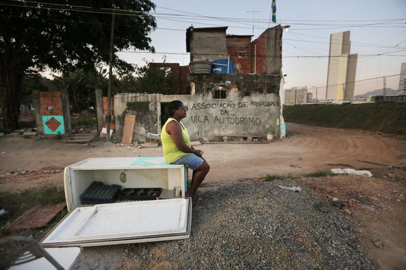 Sandra Regina sits in front of her old home while in the process of moving out in the former...