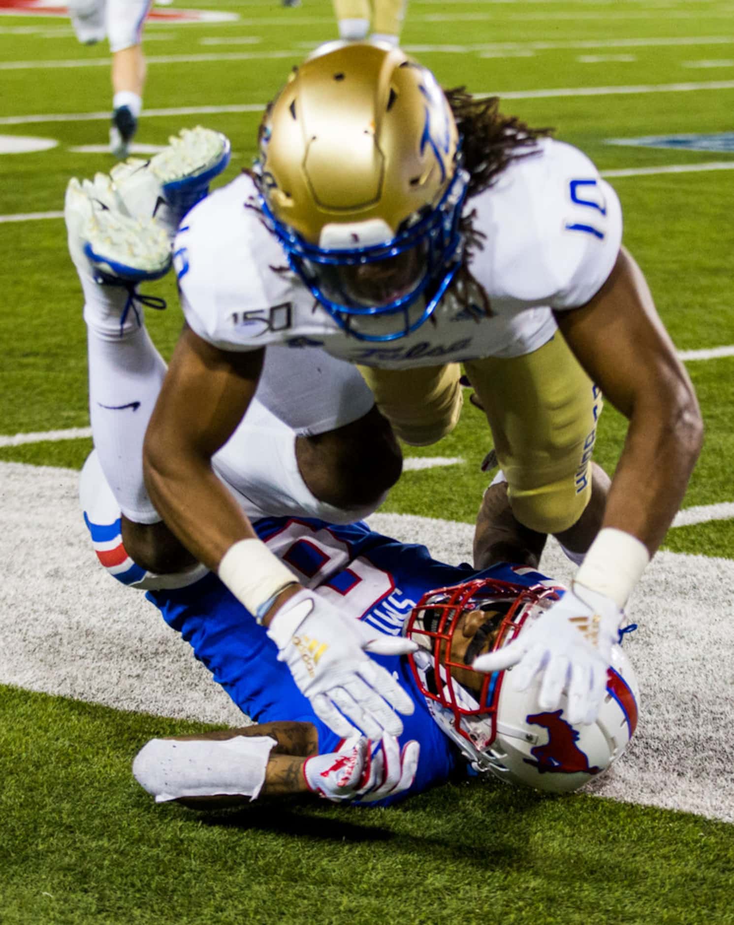 SMU Mustangs wide receiver Reggie Roberson Jr. (8) is tackled by Tulsa Golden Hurricane...