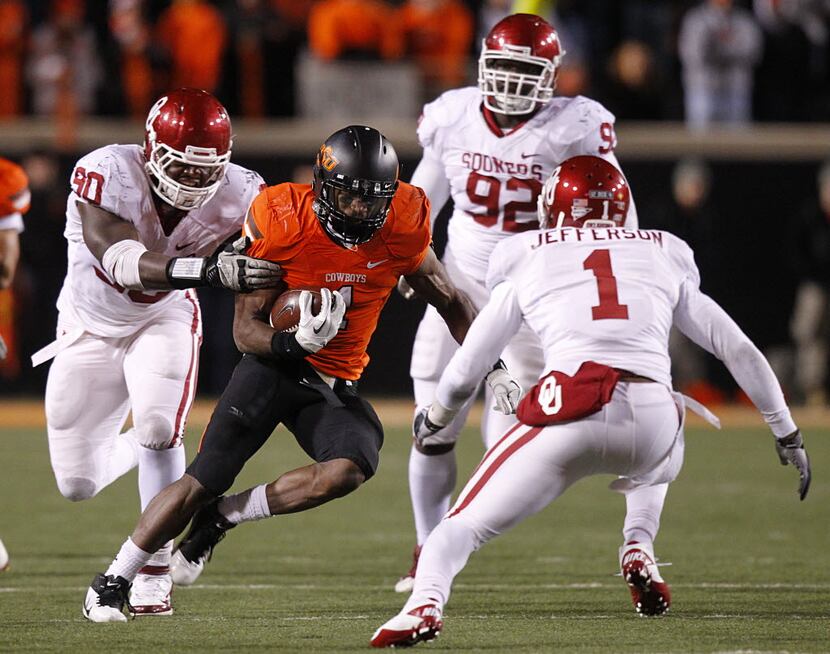Oklahoma State Cowboys wide receiver Joseph Randle (1) is tackled by Oklahoma Sooners...