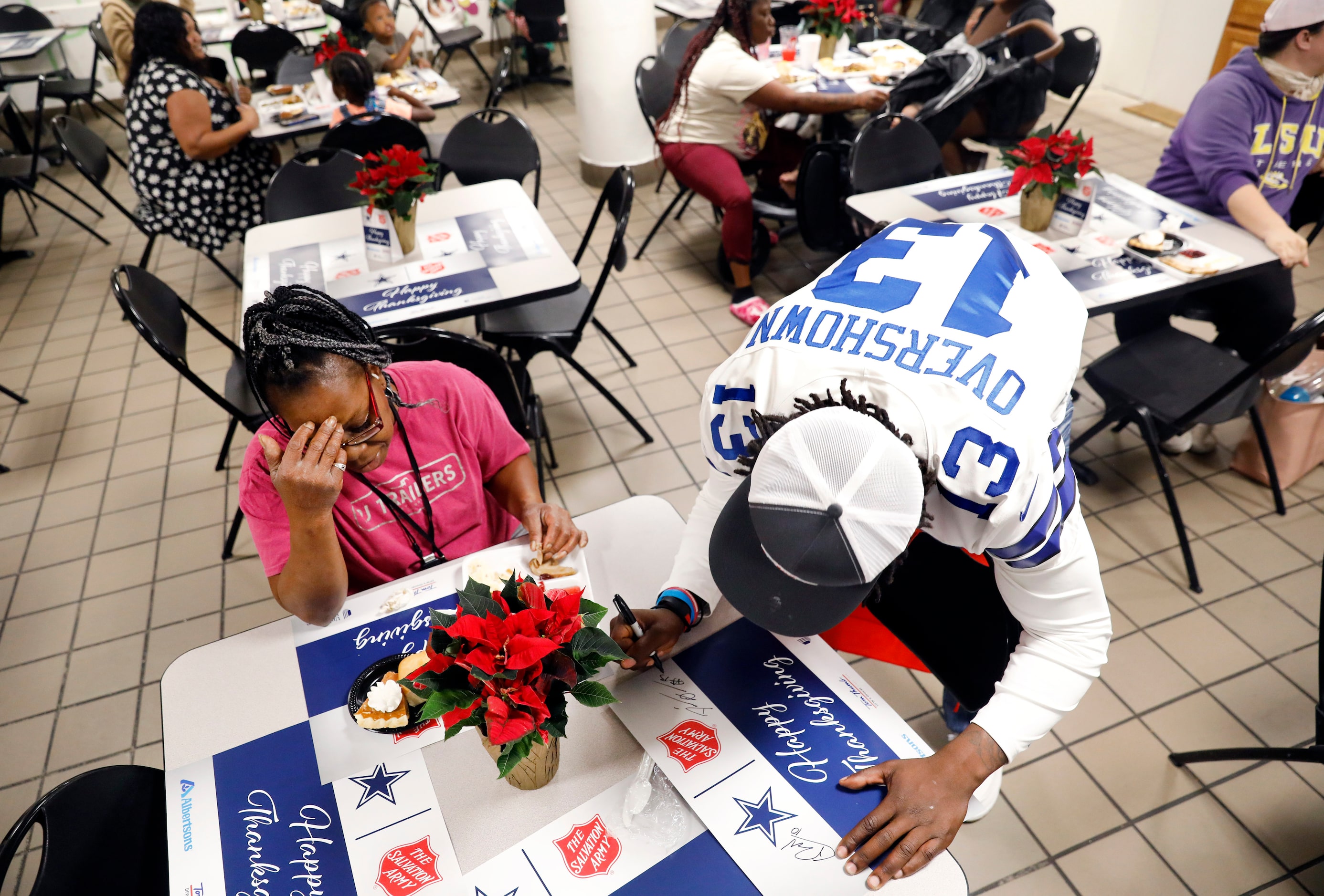 Dallas Cowboys linebacker DeMarvion Overshown signs an autograph for Rita Tennor after...