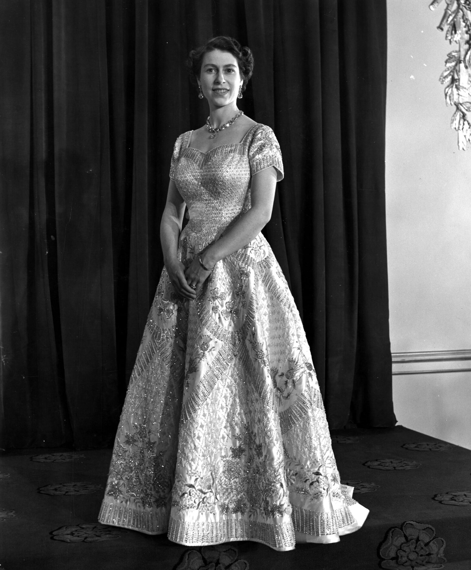 4th June 1953:  Queen Elizabeth II wearing a gown designed by Norman Hartnell for her...