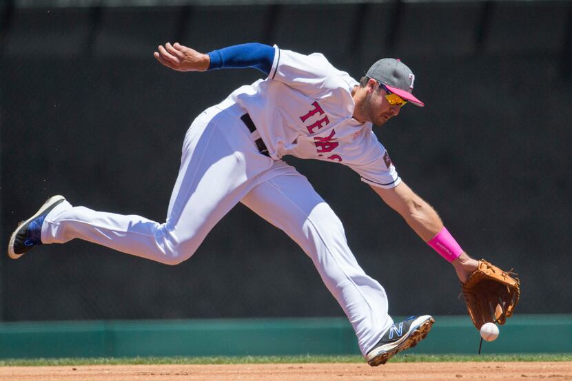 Texas Rangers third baseman Joey Gallo (13) misses a grounder hit by Oakland Athletics right...
