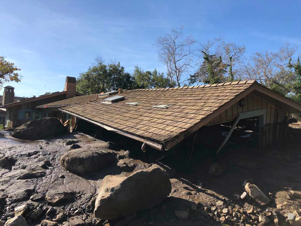 In this photo provided by Santa Barbara County Fire Department, mudflow, boulders, and...