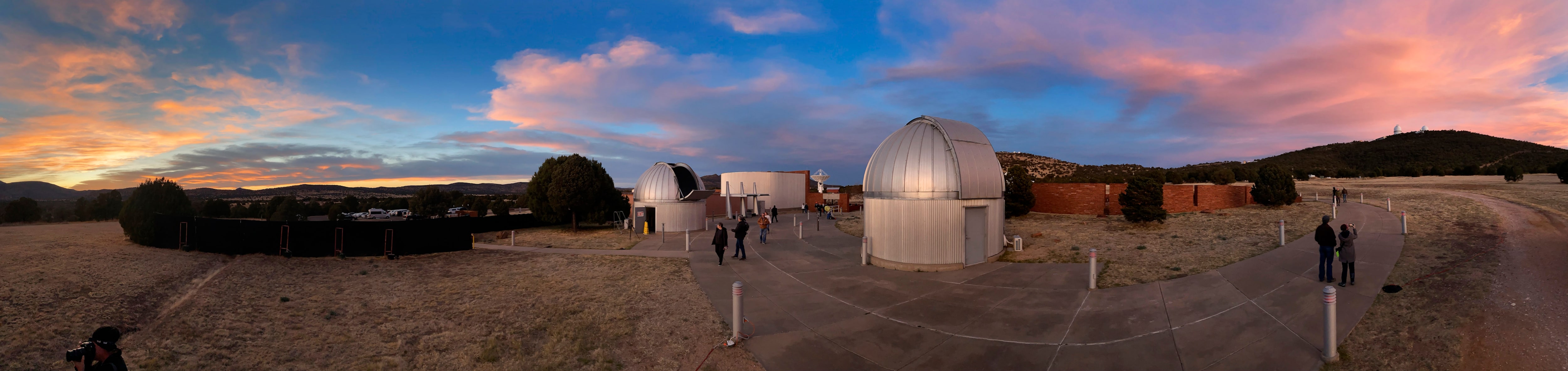 In a panoramic view, visitors walk to a star party along the red-lighted walkway in the...