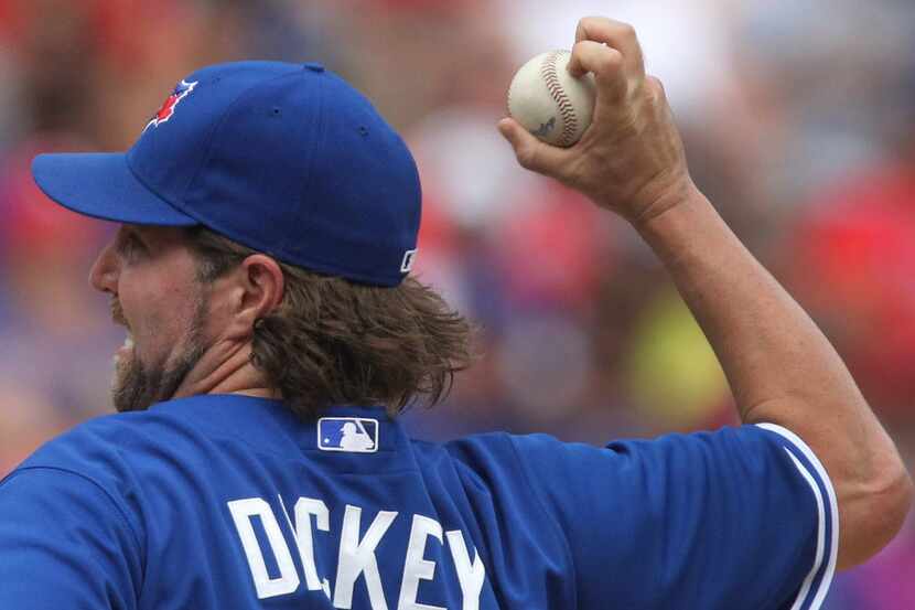 Toronto starter R.A. Dickey throws a knuckleball in the fourth inning during the Toronto...