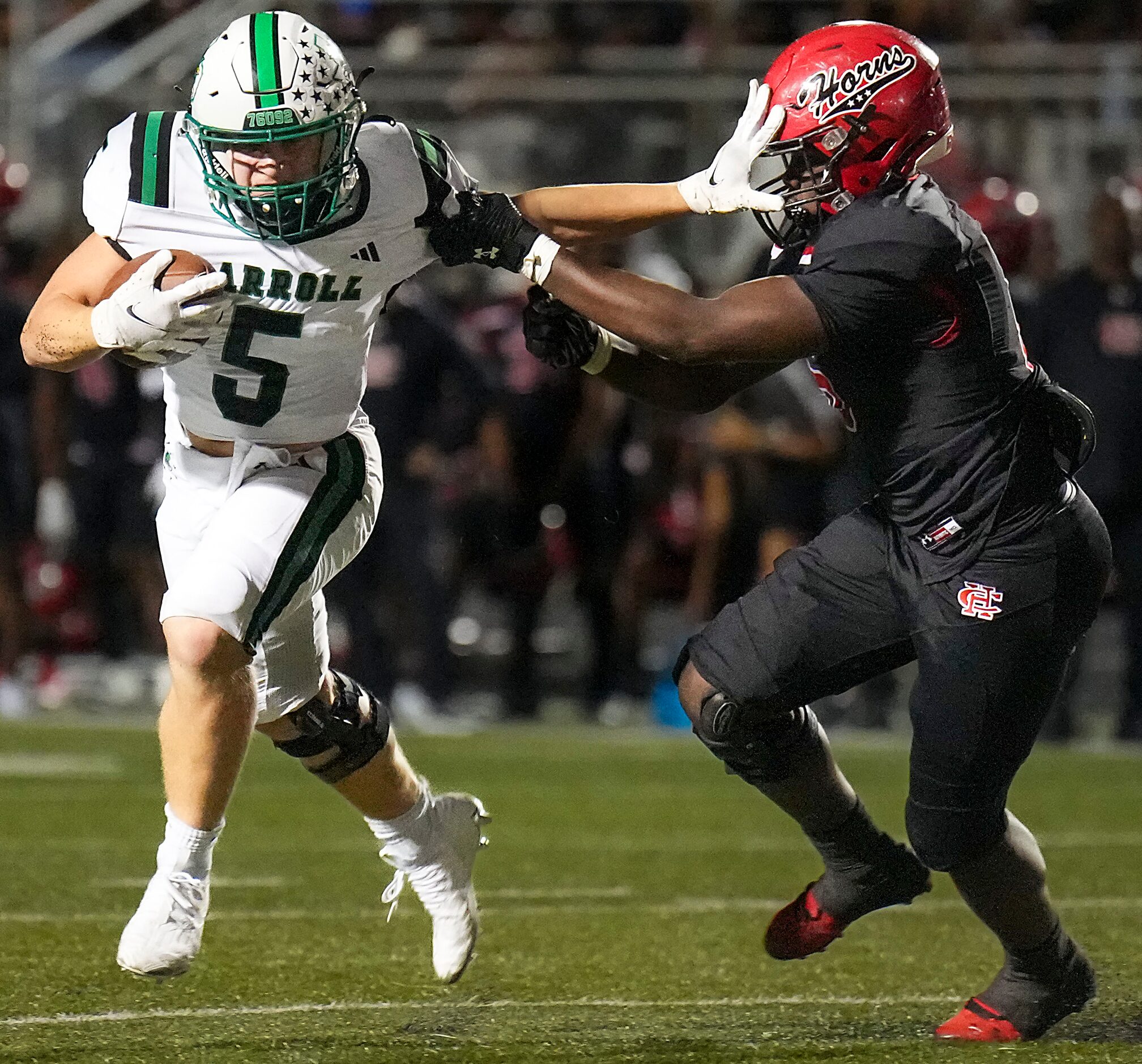 Southlake Carroll running back James Lehman (5) pushes past Cedar Hill linebacker Carlos...