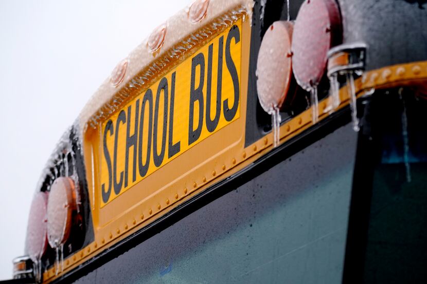 Icicles from sleet and rain coat a school bus Thursday, Feb. 2, 2023, in Richardson, Texas....