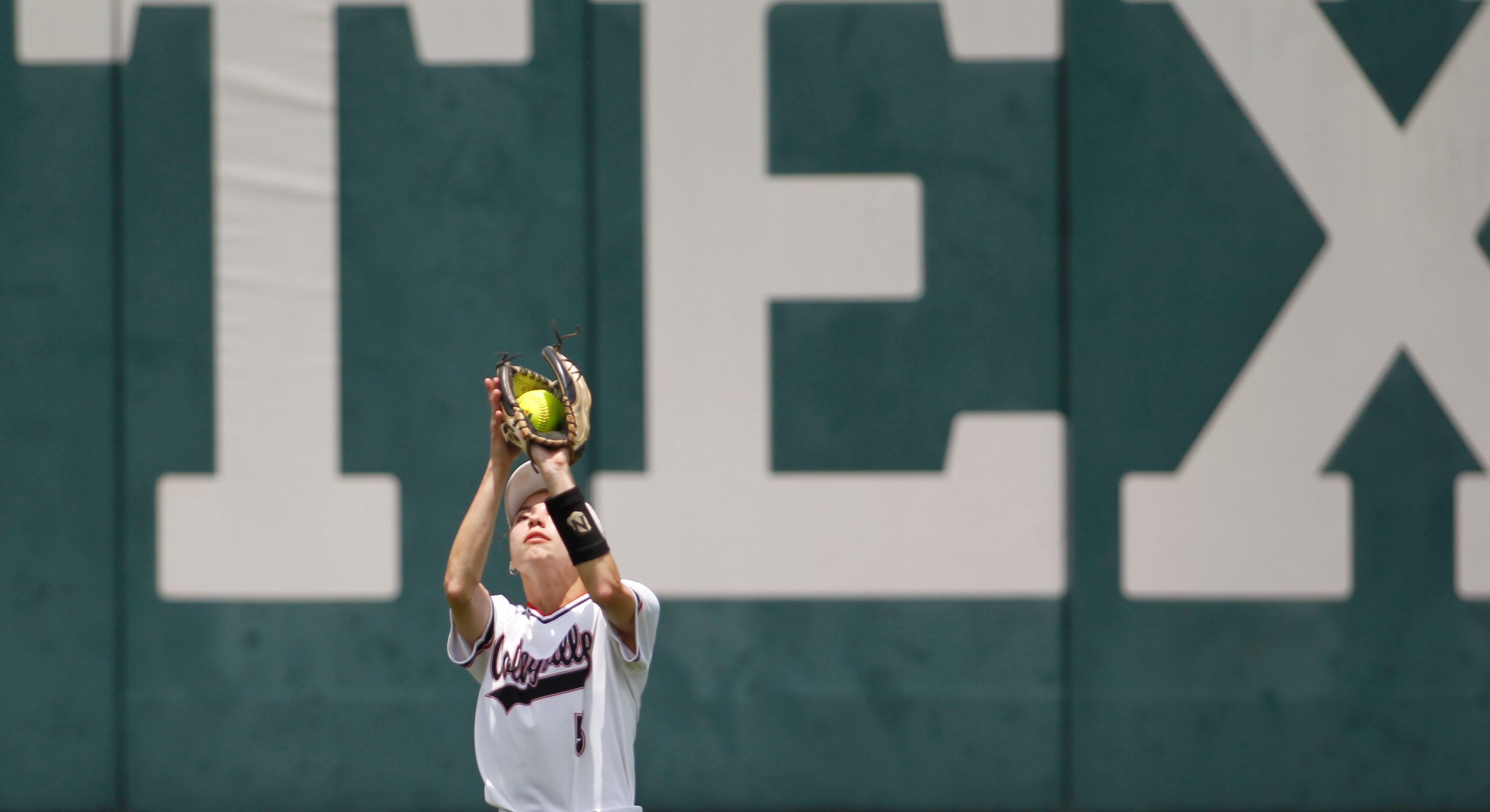 Colleyville Heritage left fielder Leah Perales (5) pulls in a fly ball during the bottom of...