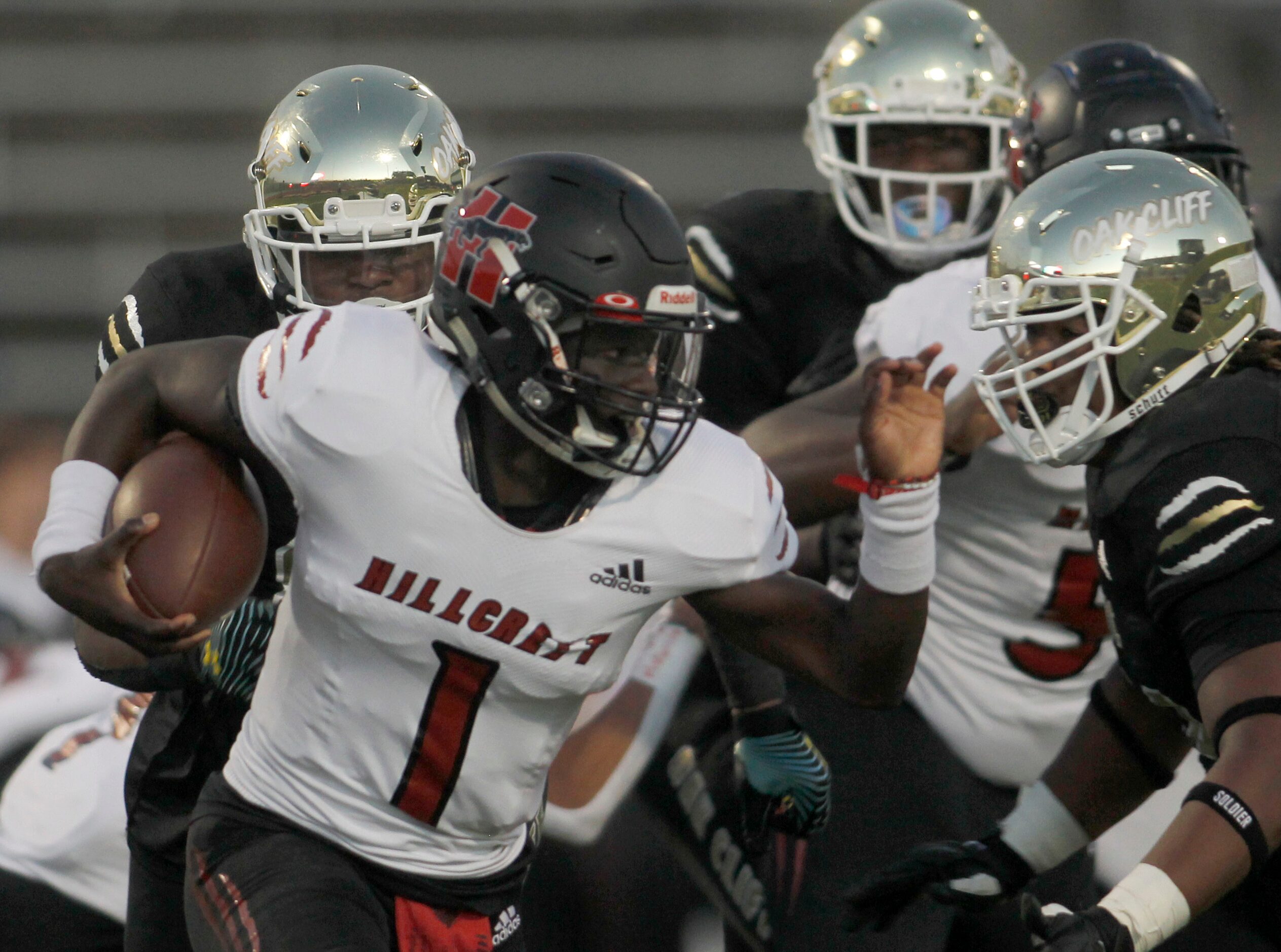 Dallas Hillcrest Carter Sido (1) tries to escape pressure from the South Oak Cliff defense...