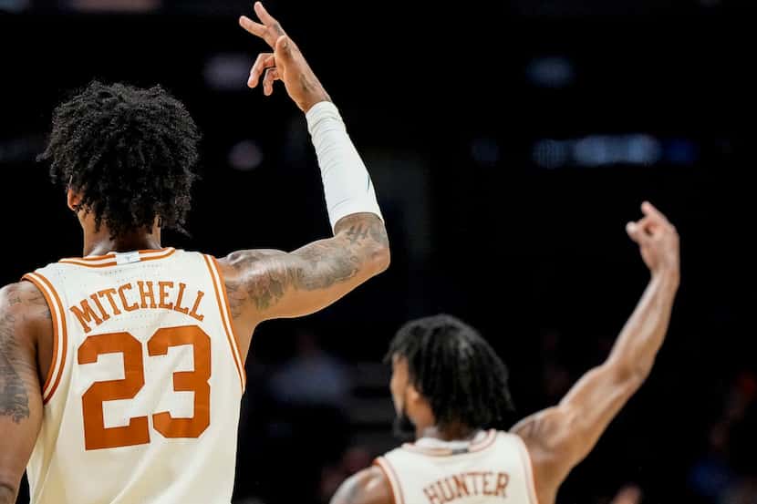 Texas forward Dillon Mitchell (23) and Texas guard Tyrese Hunter (4) celebrate a three-point...