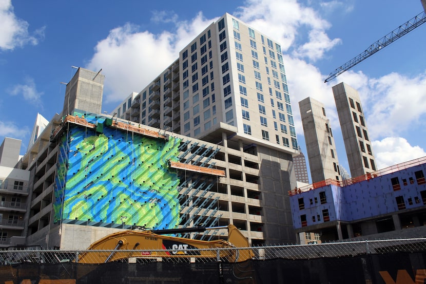 Crescent Communities' new Charlotte development hides its massive garage with a bright art...