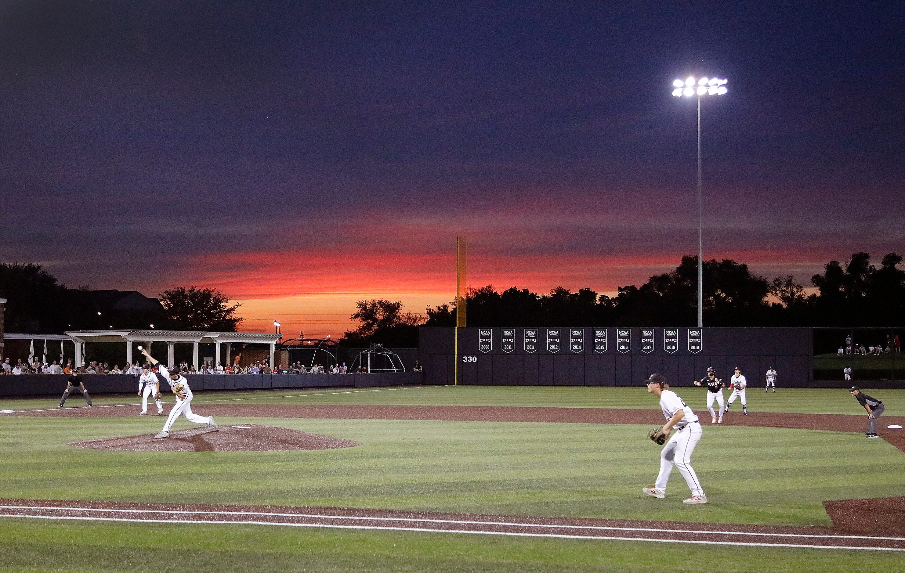 The sunset broke through in the fourth inning as Rockwall Heath High School played Rockwall...