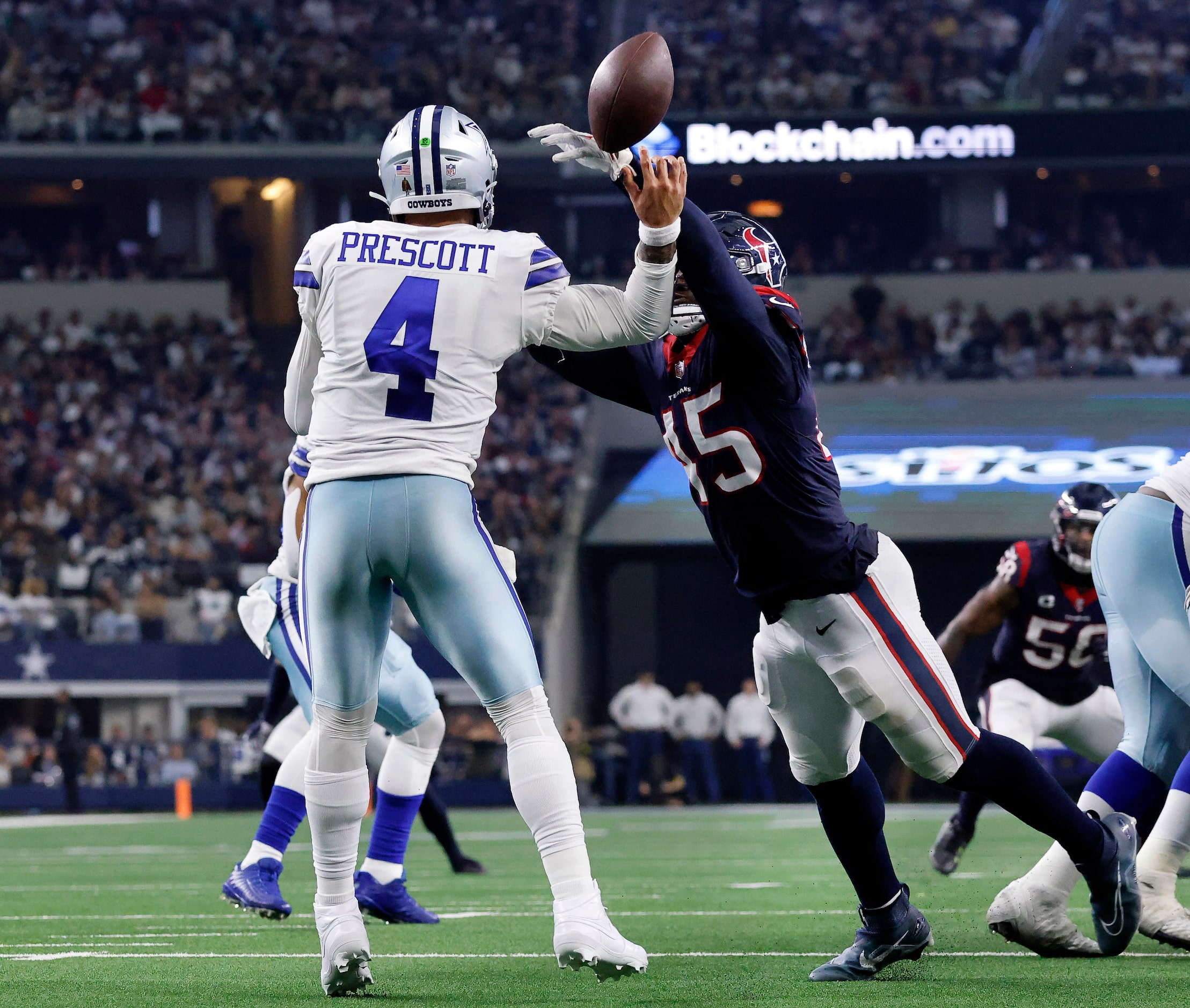 Houston Texans linebacker Ogbonnia Okoronkwo (45) knocks a pass from Dallas Cowboys...