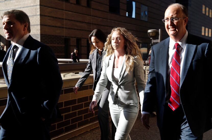 Former Dallas police officer Amber Guyger (center) leaves the Frank Crowley Courts Building...