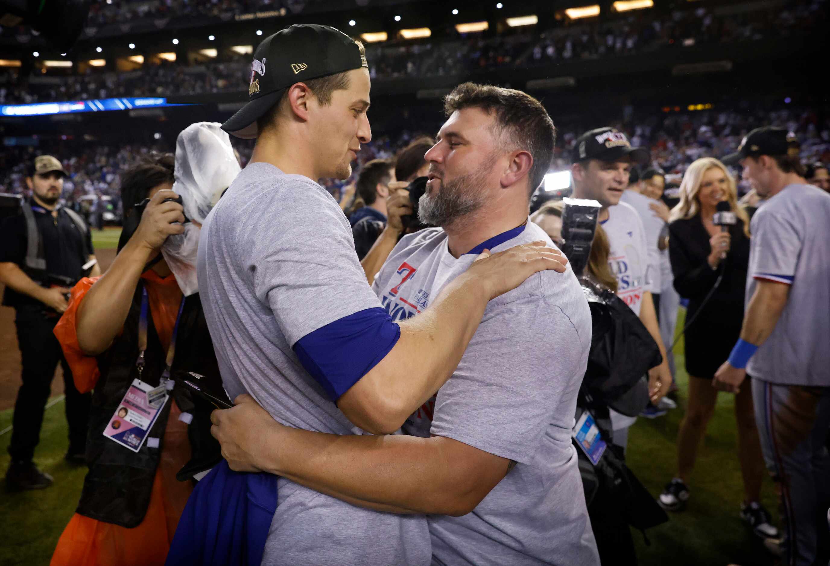 Texas Rangers catching coach Bobby Wilson hugs shortstop Corey Seager (5) as they celebrate...
