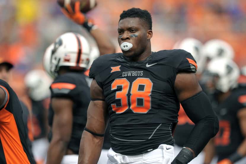 Oklahoma State defensive end Emmanuel Ogbah is pictured before the start of an NCAA college...