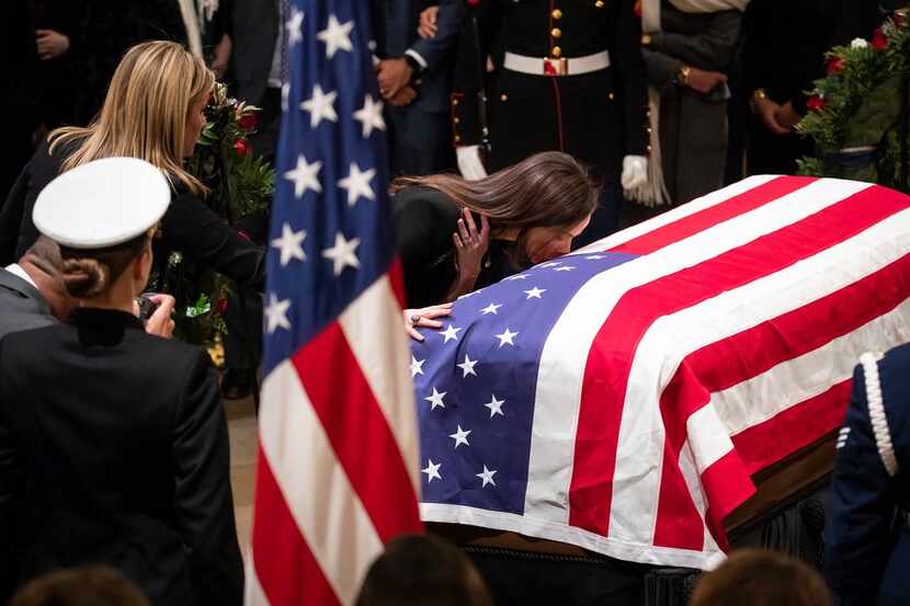 Barbara Pierce Bush kisses the flag-draped casket of her grandfather President George H.W....