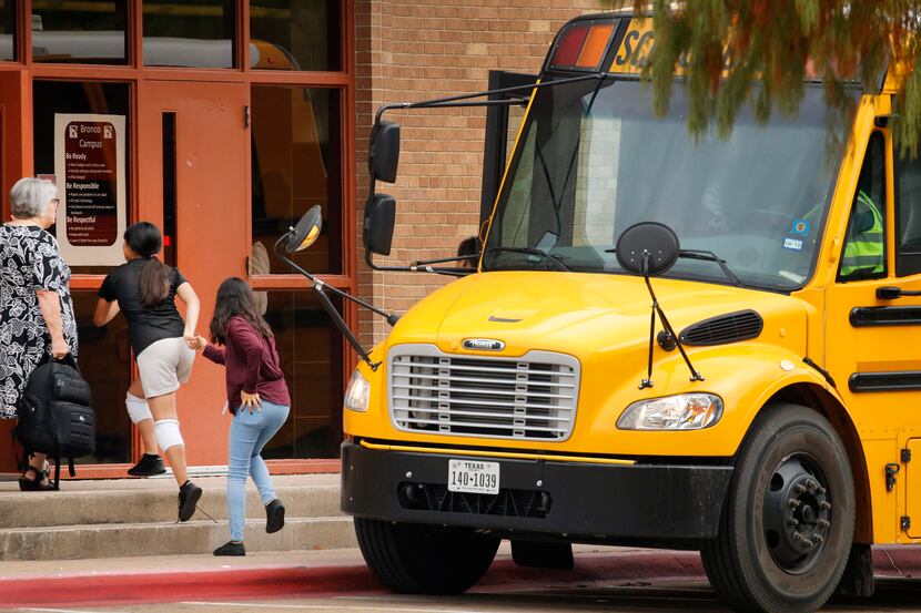 Students enter the front door of Stephen F. Austin Middle School in Irving, Texas in...